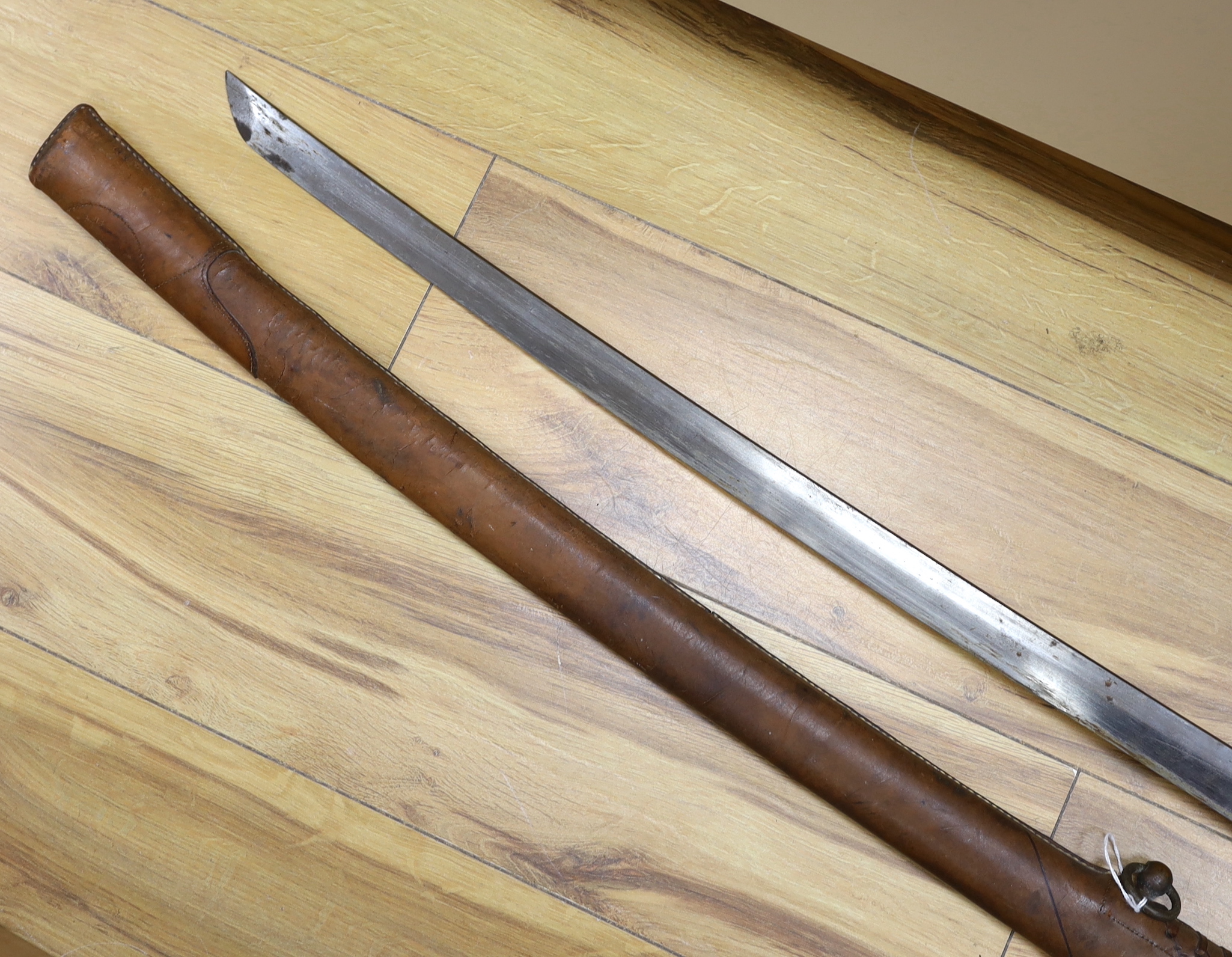 A Japanese WWII Shin gunto (sword) and leather mounted scabbard